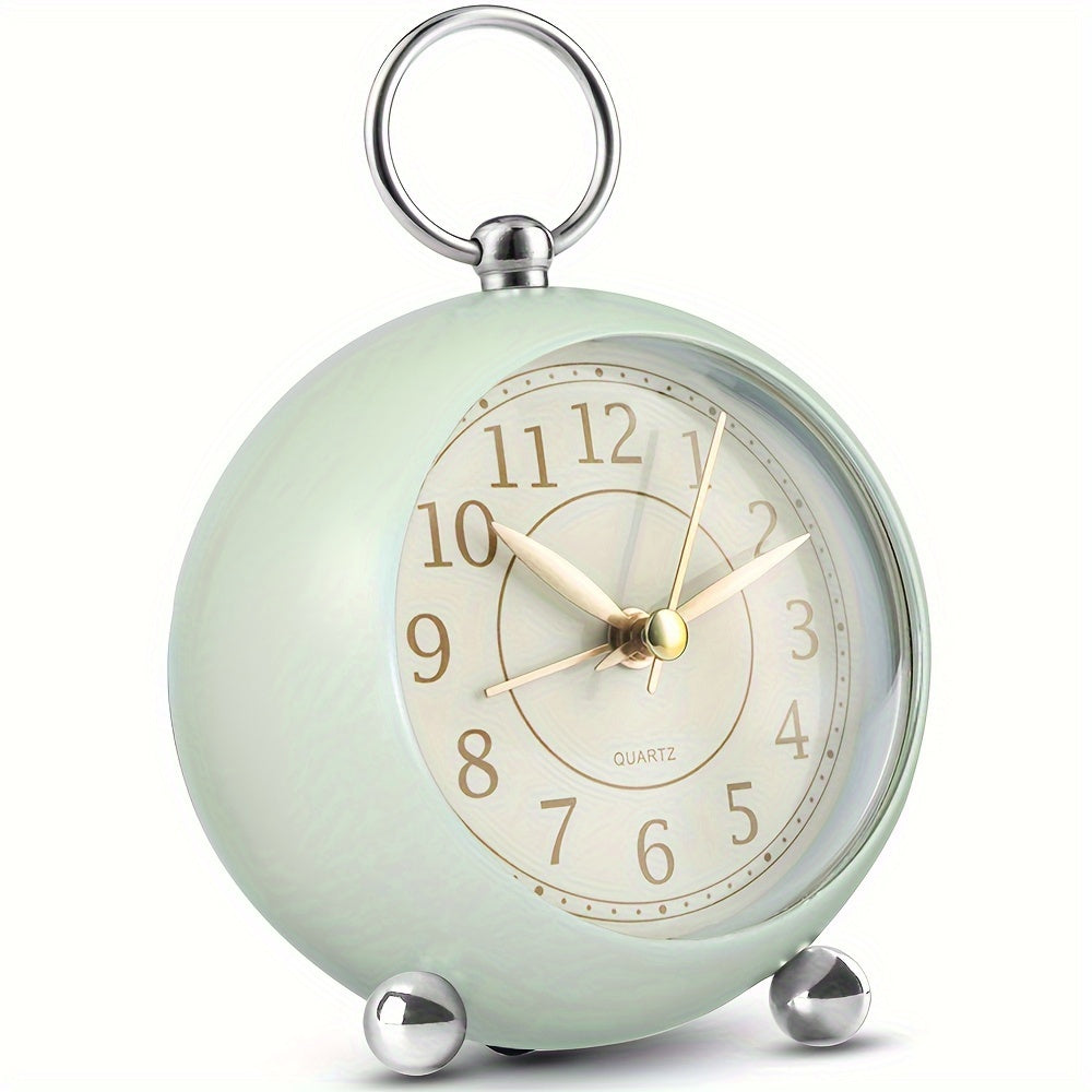 Round travel alarm clock with a light