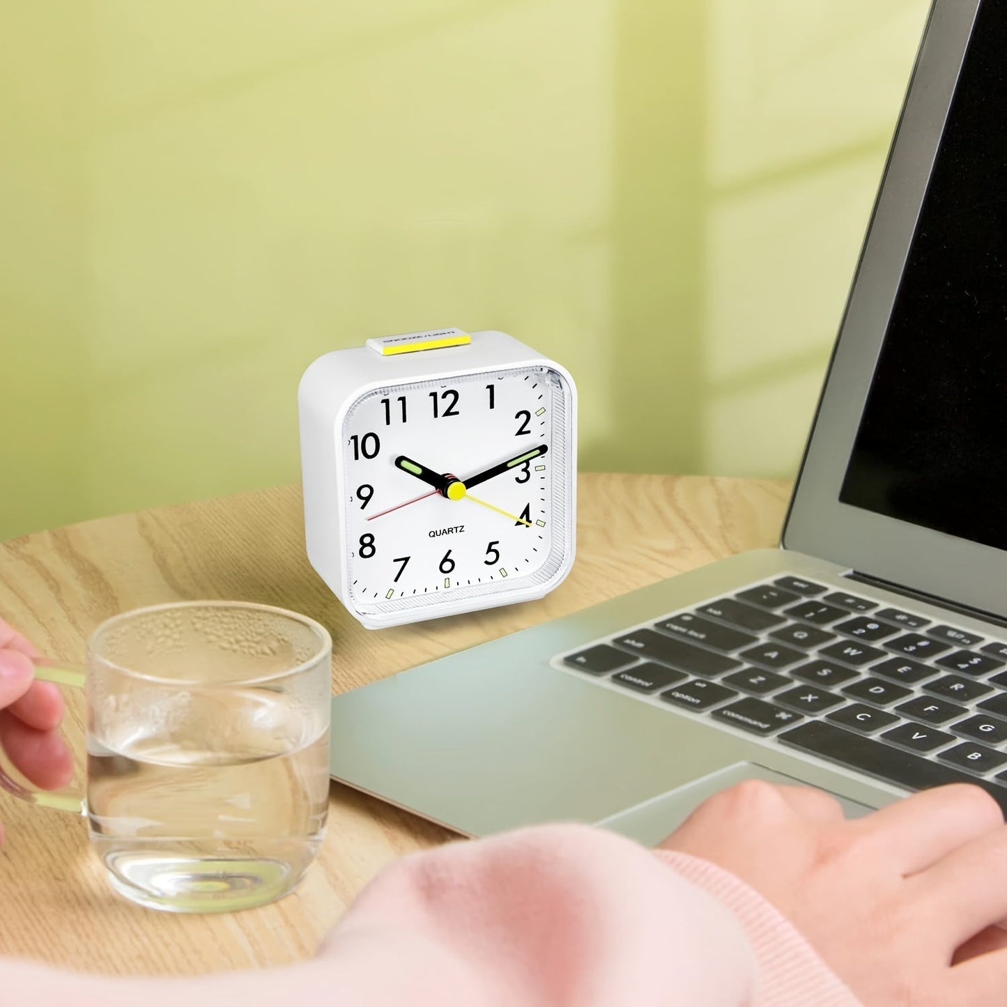 Travel alarm clock with luminous hands