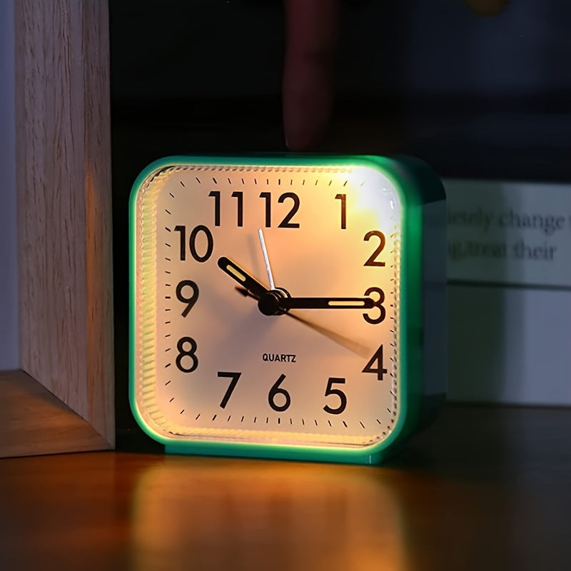 Travel alarm clock with illuminated hands