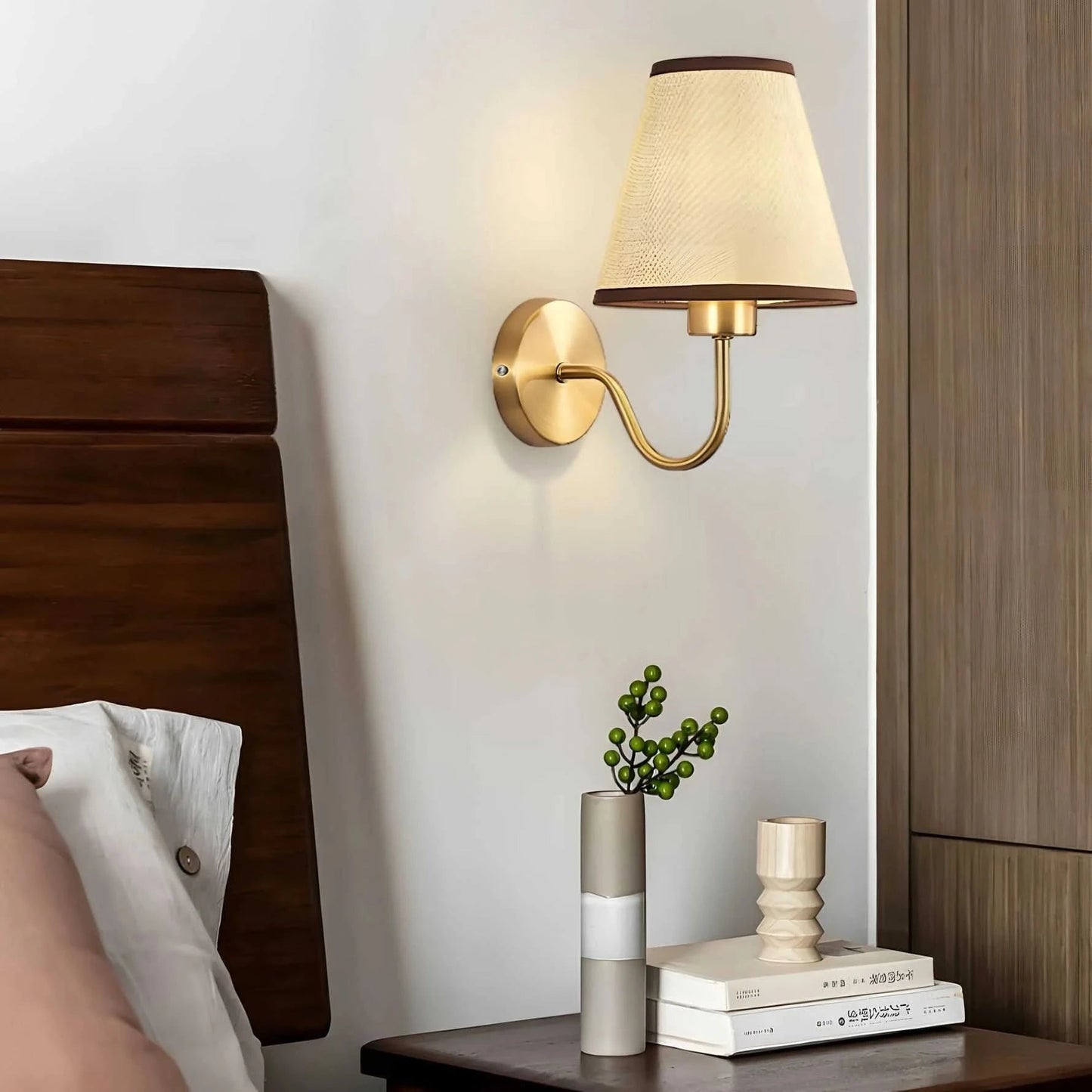 Wall light with a lampshade and gold arm