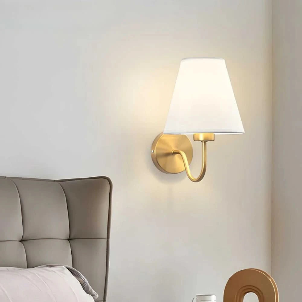 Wall light with a lampshade and gold arm
