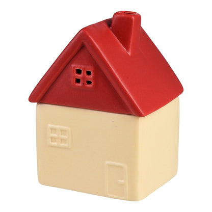 Pink candle in a little house