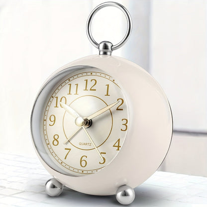 Round travel alarm clock with a light