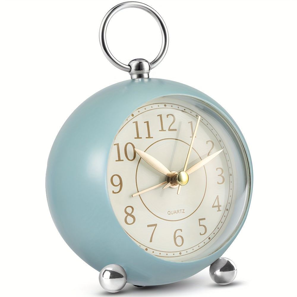 Round travel alarm clock with a light