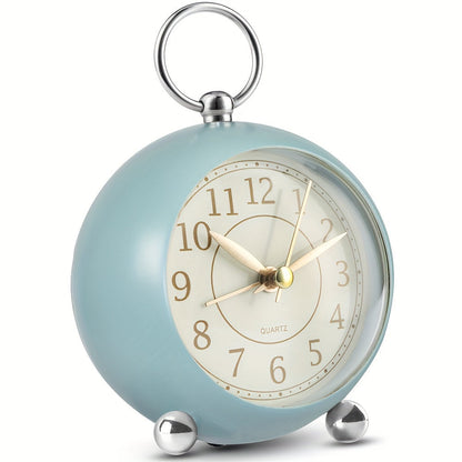 Round travel alarm clock with a light