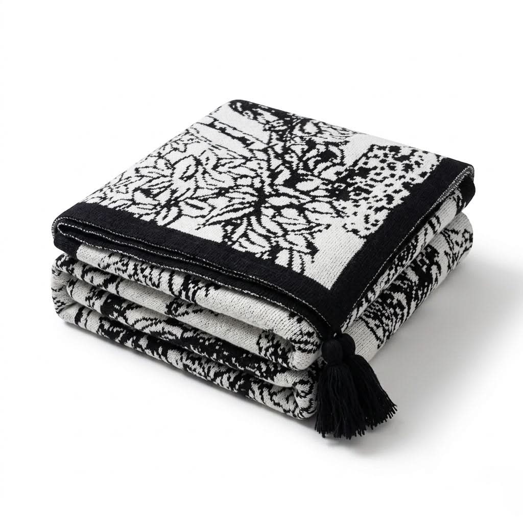 Couverture tricotée avec des fleurs et des oiseaux